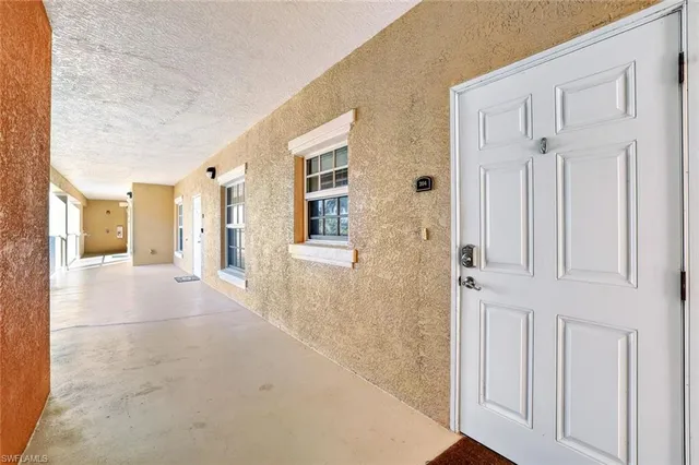 a view of a hallway with wooden cabinets