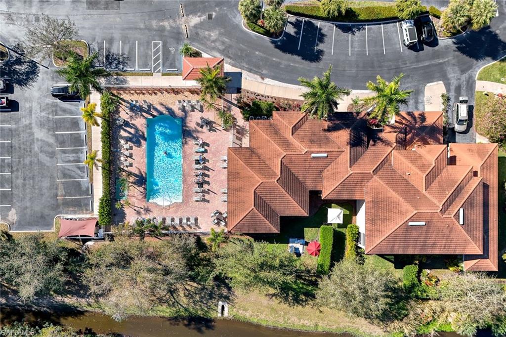 4455 Botanical Pl Circle, Unit 204 Naples, FL 34112 - Photo 23 of 26 an aerial view of a house with a yard and a fountain