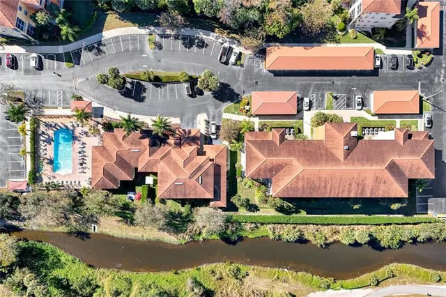 an aerial view of residential houses with outdoor space and swimming pool