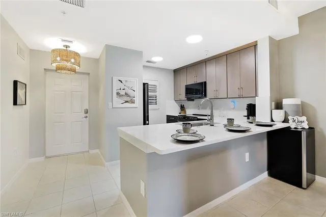 a kitchen with sink cabinets and appliances