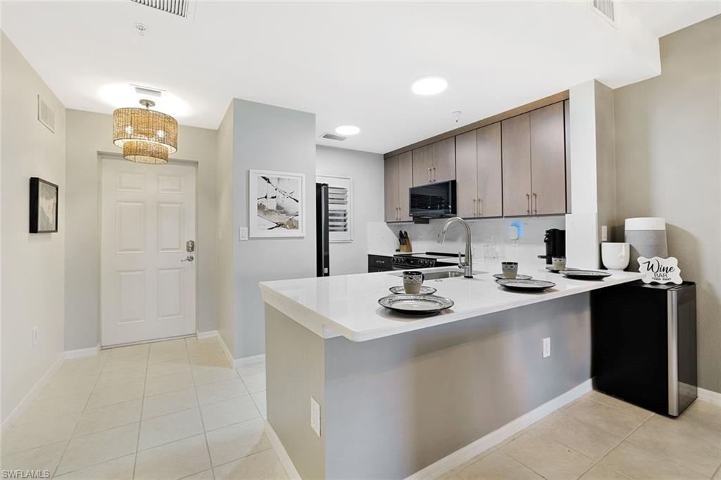4455 Botanical Pl Circle, Unit 204 Naples, FL 34112 - Photo 3 of 26 a kitchen with sink cabinets and appliances