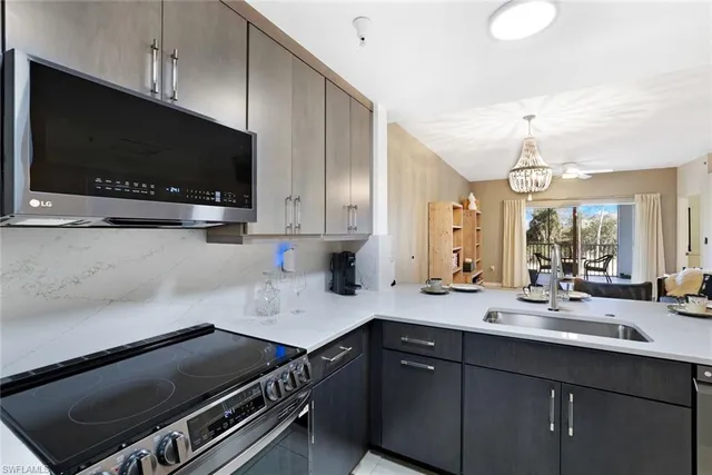 a kitchen with a sink a microwave and cabinets