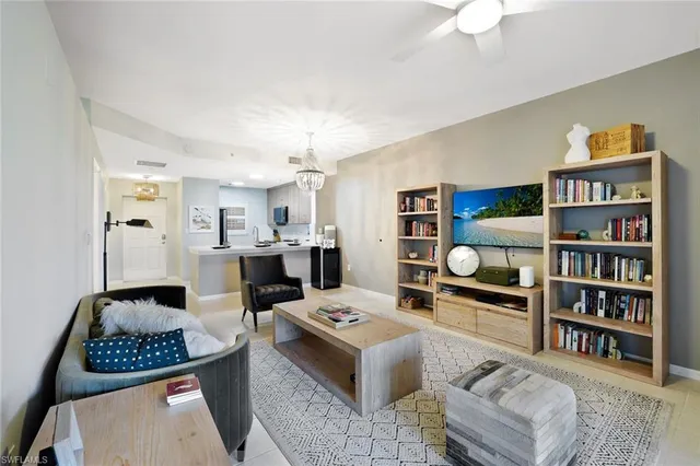 a living room with furniture and a book shelf