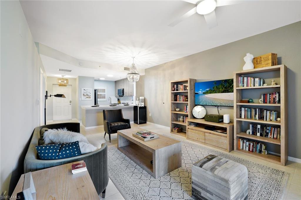 4455 Botanical Pl Circle, Unit 204 Naples, FL 34112 - Photo 7 of 26 a living room with furniture and a book shelf