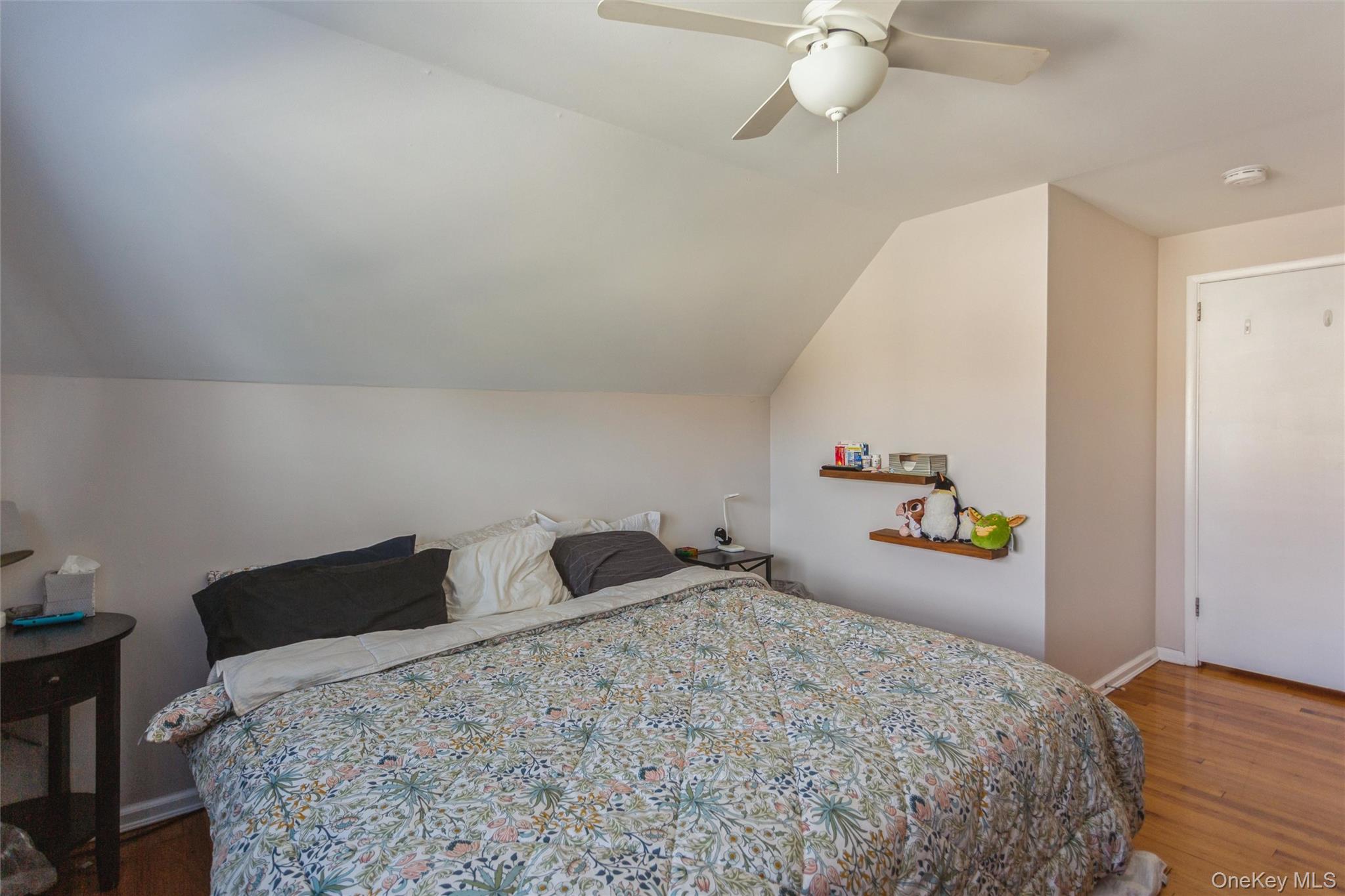 1531 Merrick Avenue Merrick, NY 11566 - Photo 15 of 26 Bedroom featuring wood finished floors, lofted ceiling, and a ceiling fan