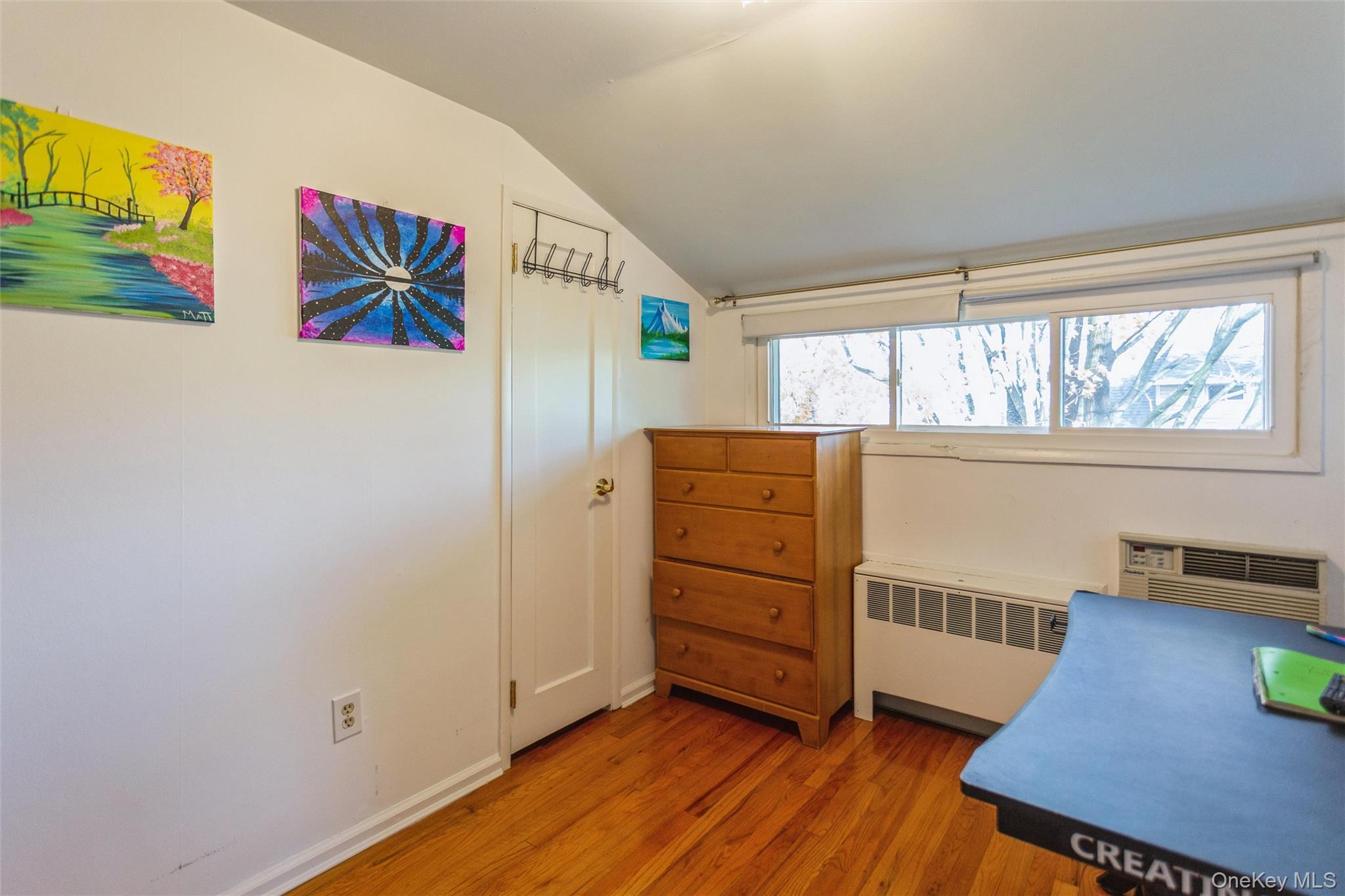1531 Merrick Avenue Merrick, NY 11566 - Photo 21 of 26 Office with lofted ceiling, radiator heating unit, light wood-type flooring, and a wall unit AC