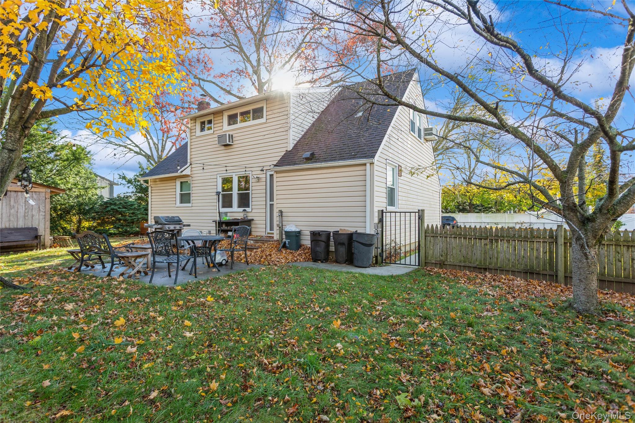 1531 Merrick Avenue Merrick, NY 11566 - Photo 26 of 26 Back of house featuring a patio area, a fenced backyard, and a shingled roof