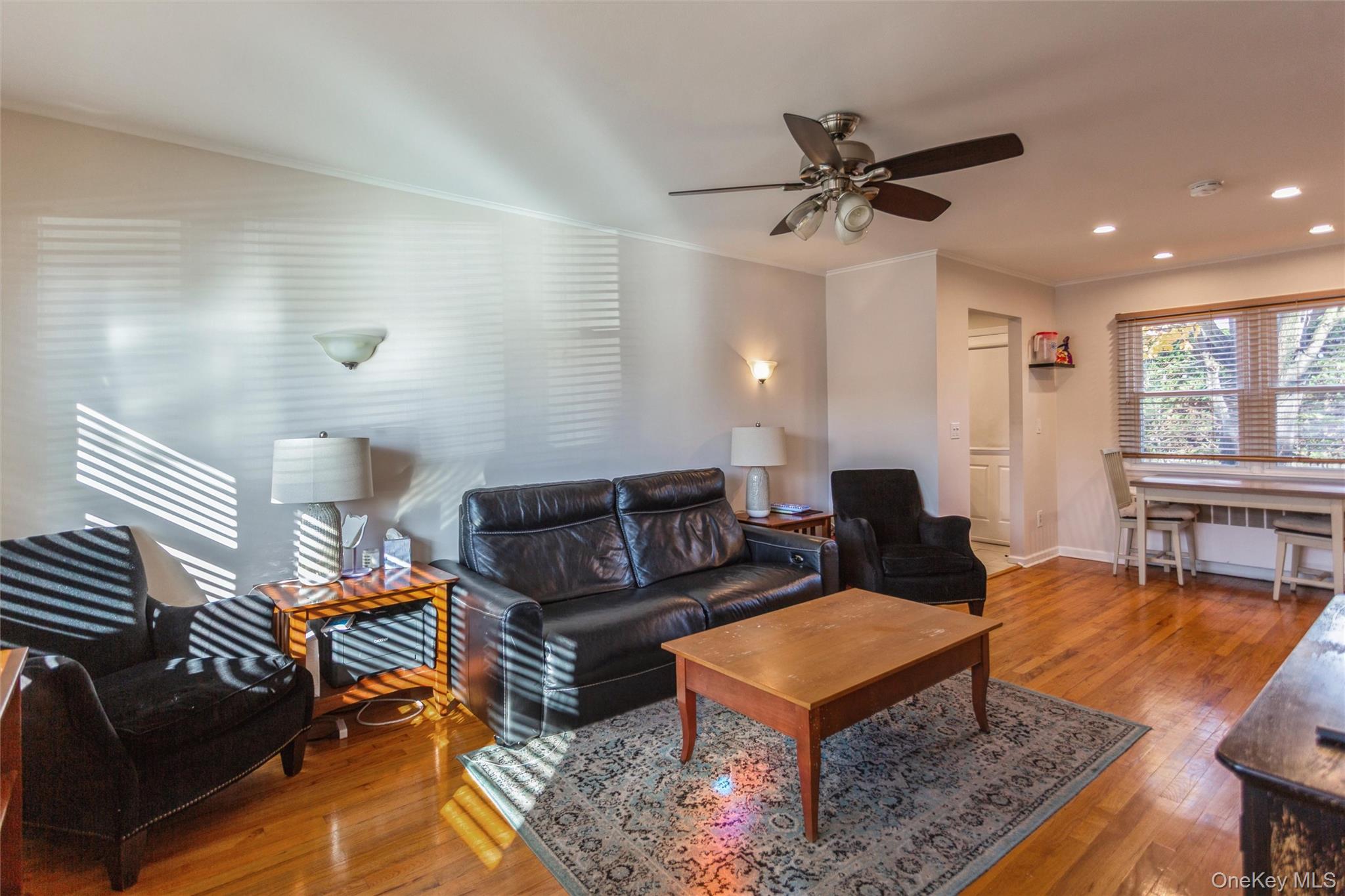 1531 Merrick Avenue Merrick, NY 11566 - Photo 9 of 26 Living area with hardwood / wood-style floors, ornamental molding, ceiling fan, and recessed lighting