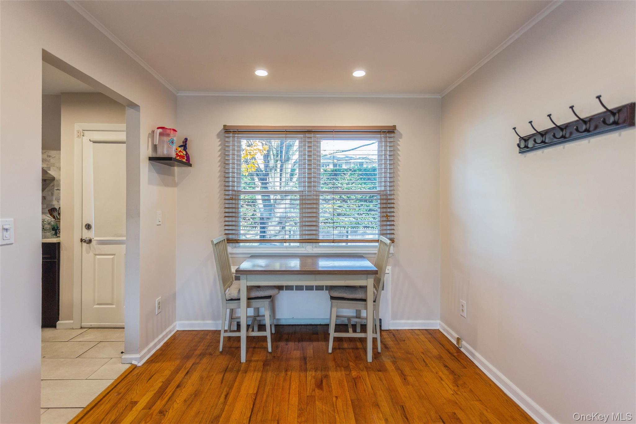 1531 Merrick Avenue Merrick, NY 11566 - Photo 10 of 26 Dining area featuring light wood finished floors, crown molding, and recessed lighting