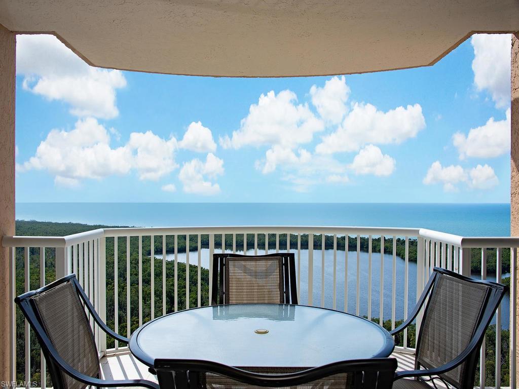 6849 Grenadier Boulevard, Unit 2104 Naples, FL 34108 - Photo 2 of 13 a view of a chair and table on the roof deck