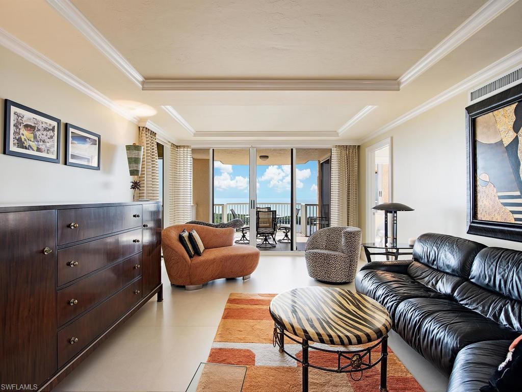 6849 Grenadier Boulevard, Unit 2104 Naples, FL 34108 - Photo 5 of 13 a living room with furniture and a large window
