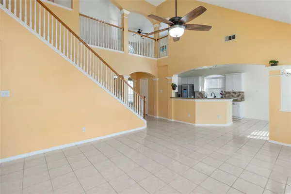 a view of a kitchen with furniture and ceiling fan
