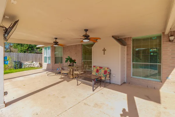 a view of a house with backyard porch and sitting area
