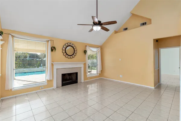 a view of empty room with fireplace and fan