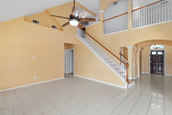 a view of staircase with railing and white walls
