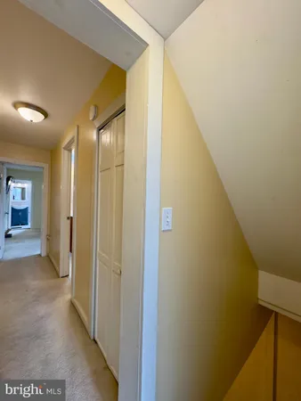 a view of a hallway with wooden shelves