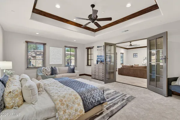 a front view of a house with a yard and potted plants