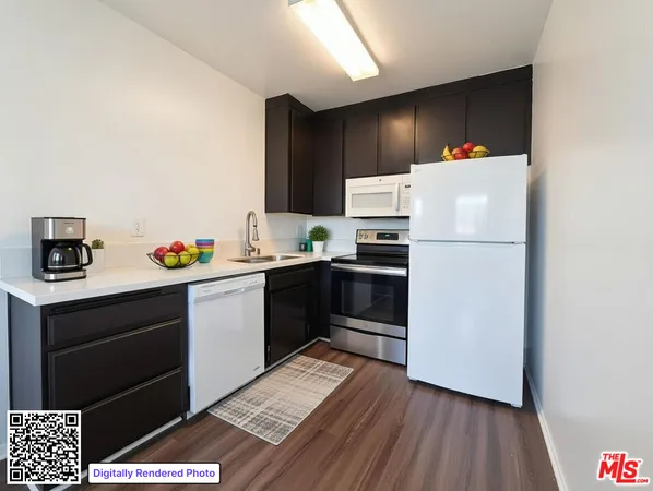 a kitchen with a refrigerator and a stove top oven
