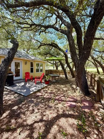 a view of a house with a tree tree front of it