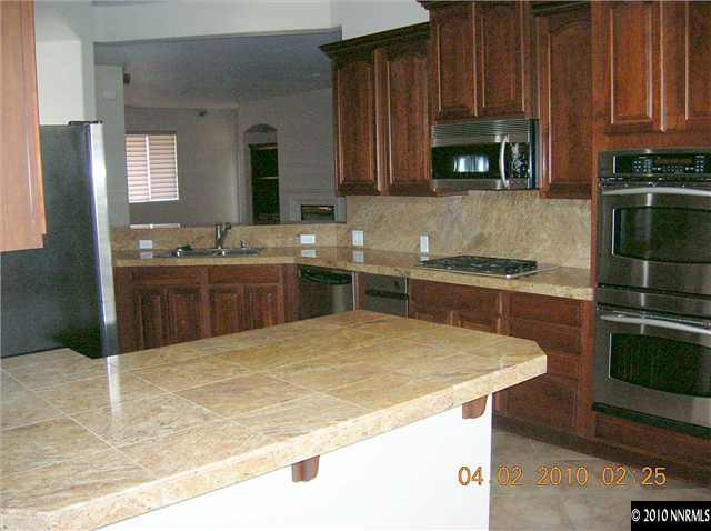 9900 Wilbur May, Unit 2601 Reno, NV 89521 - Photo 4 of 9 a kitchen with a sink and cabinets