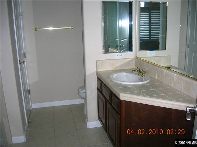 9900 Wilbur May, Unit 2601 Reno, NV 89521 - Photo 8 of 9 a bathroom with a sink and a mirror