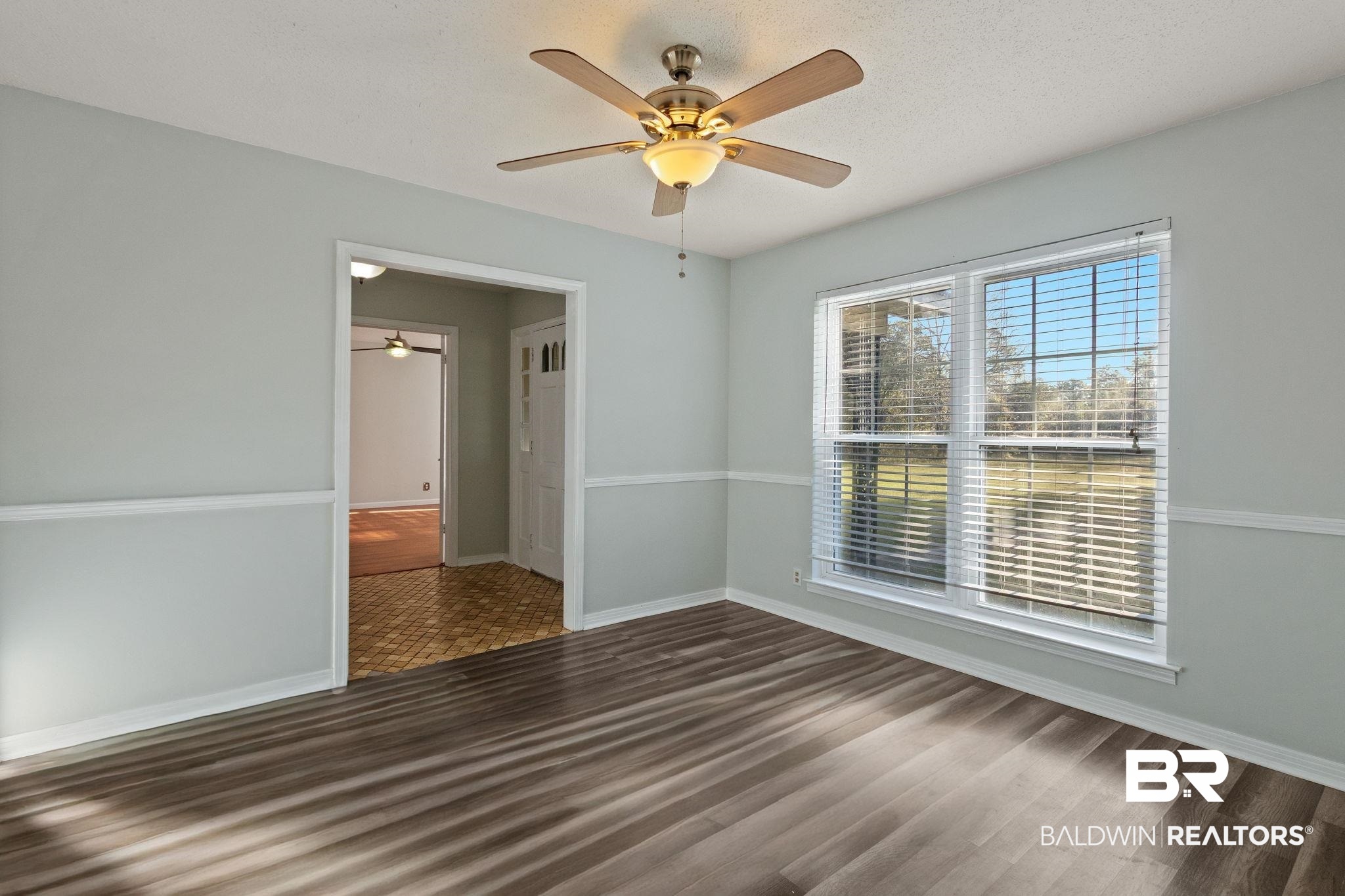 3864 Leroy Stevens Road Mobile, AL 36619 - Photo 8 of 33 Unfurnished room featuring dark wood-style floors, ceiling fan, and a textured ceiling