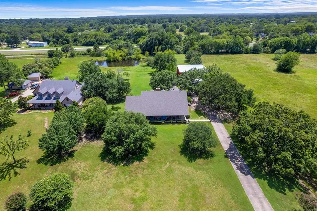an aerial view of a houses with outdoor space and a lake view