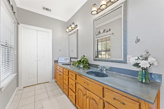 a spacious bathroom with stainless steel appliances a sink and a mirror