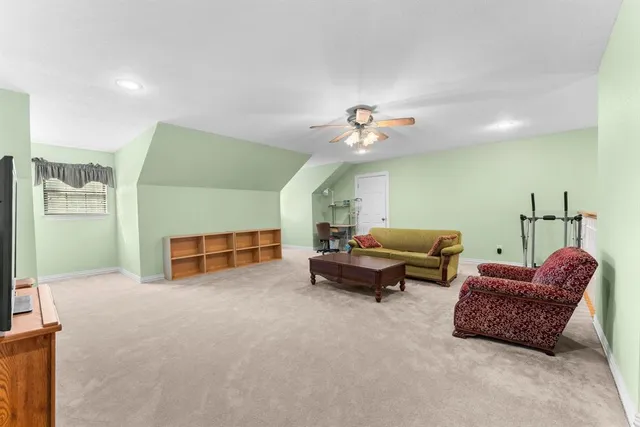 an aerial view of a house with a yard and a large tree