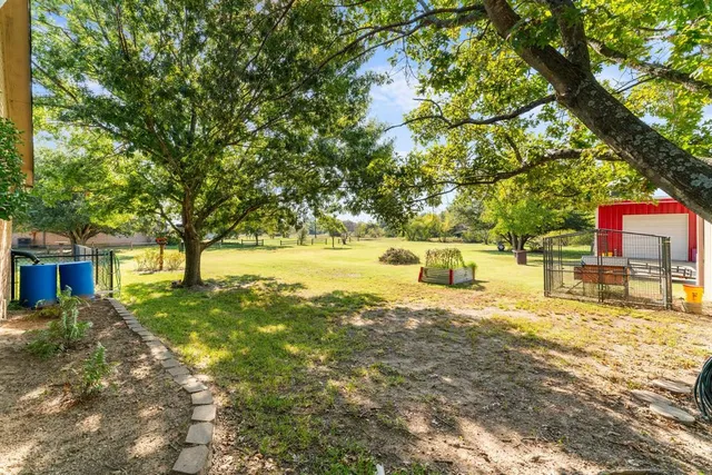 a swimming pool with outdoor seating and yard