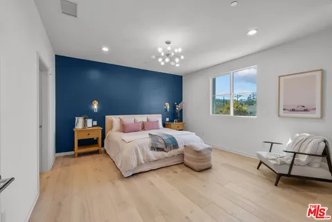 a bedroom with a bed and a couch