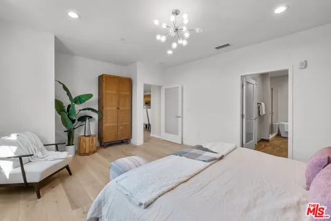 a bedroom with a bed and ceiling fan