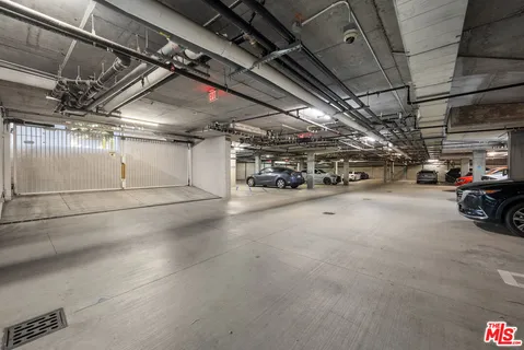 a view of parking garage with cars
