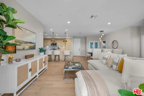 a living room with furniture and a potted plant