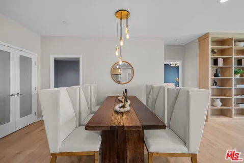 a living room with furniture a window and wooden floor