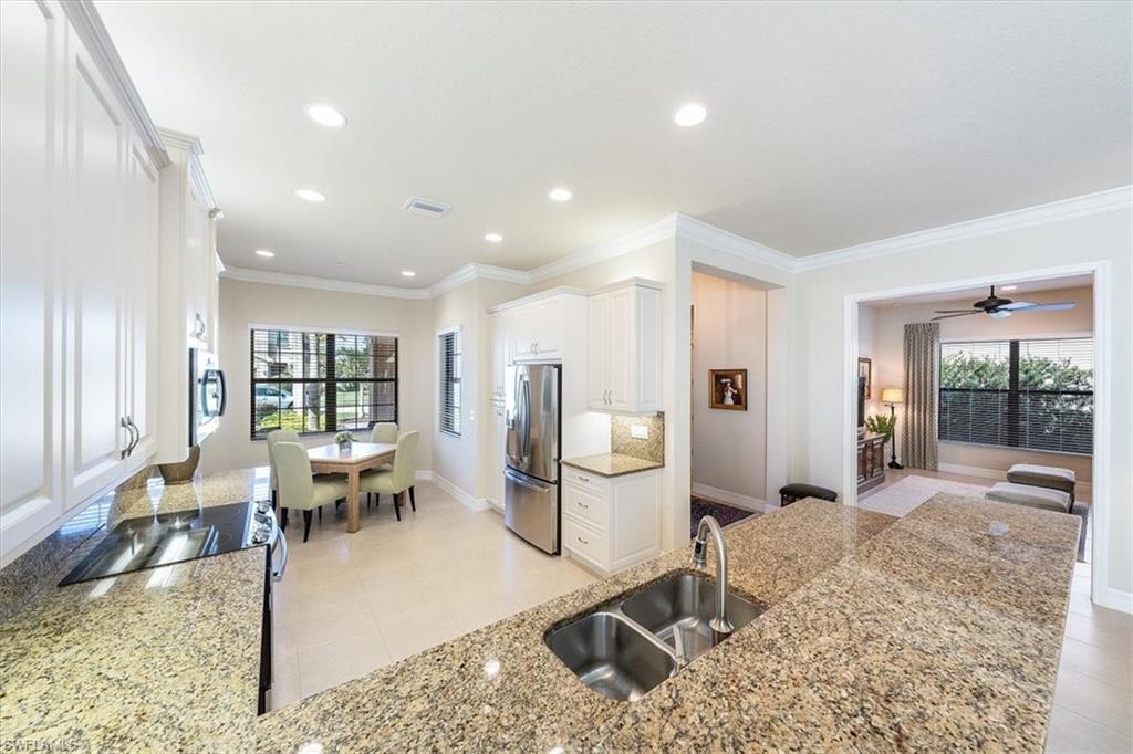 13644 Mandarin Circle Naples, FL 34109 - Photo 6 of 20 Upgraded eat-in Kitchen with upgraded lighting and cabinetry
