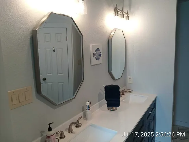 a bathroom with a sink a toilet and mirror