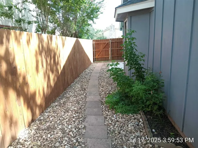 a backyard of a house with a garden and deck