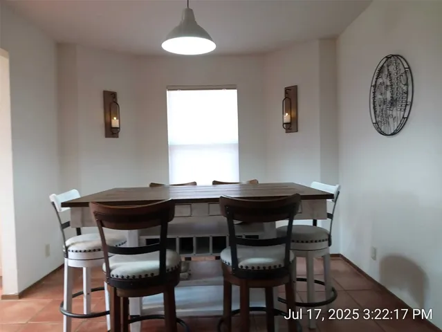 a view of a dining room with furniture and a window