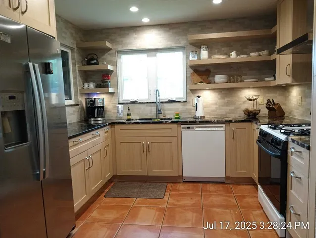 a kitchen with a sink a stove and refrigerator