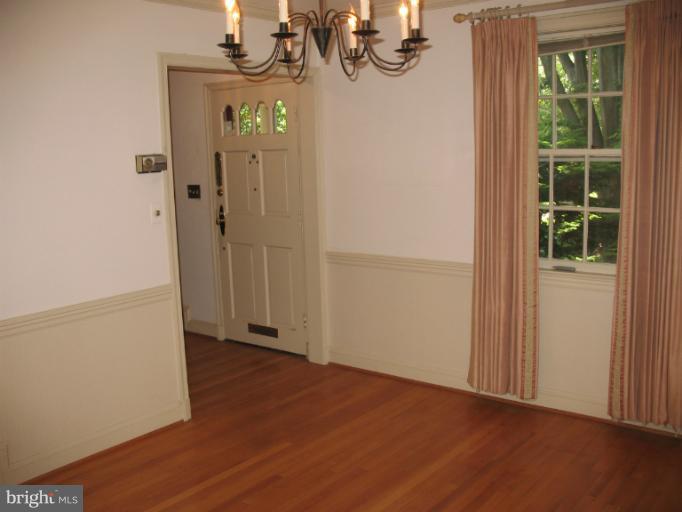 602 Coventry Road Towson, MD 21286 - Photo 23 of 28 an empty room with wooden floor and windows