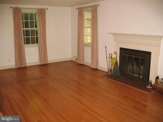 602 Coventry Road Towson, MD 21286 - Photo 5 of 28 an empty room with windows and fireplace