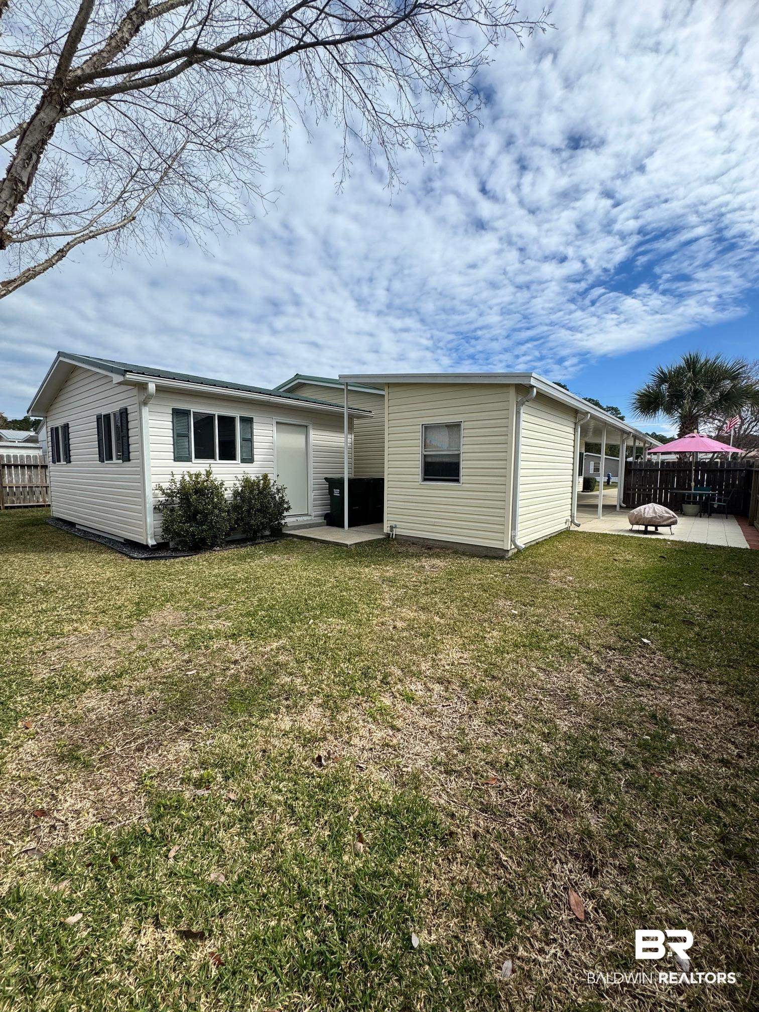 1165 Santa Anna Lane Lillian, AL 36549 - Photo 23 of 43 Rear view of property with a patio area, a lawn, and fence