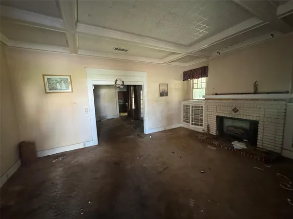 a view of empty room with a fireplace