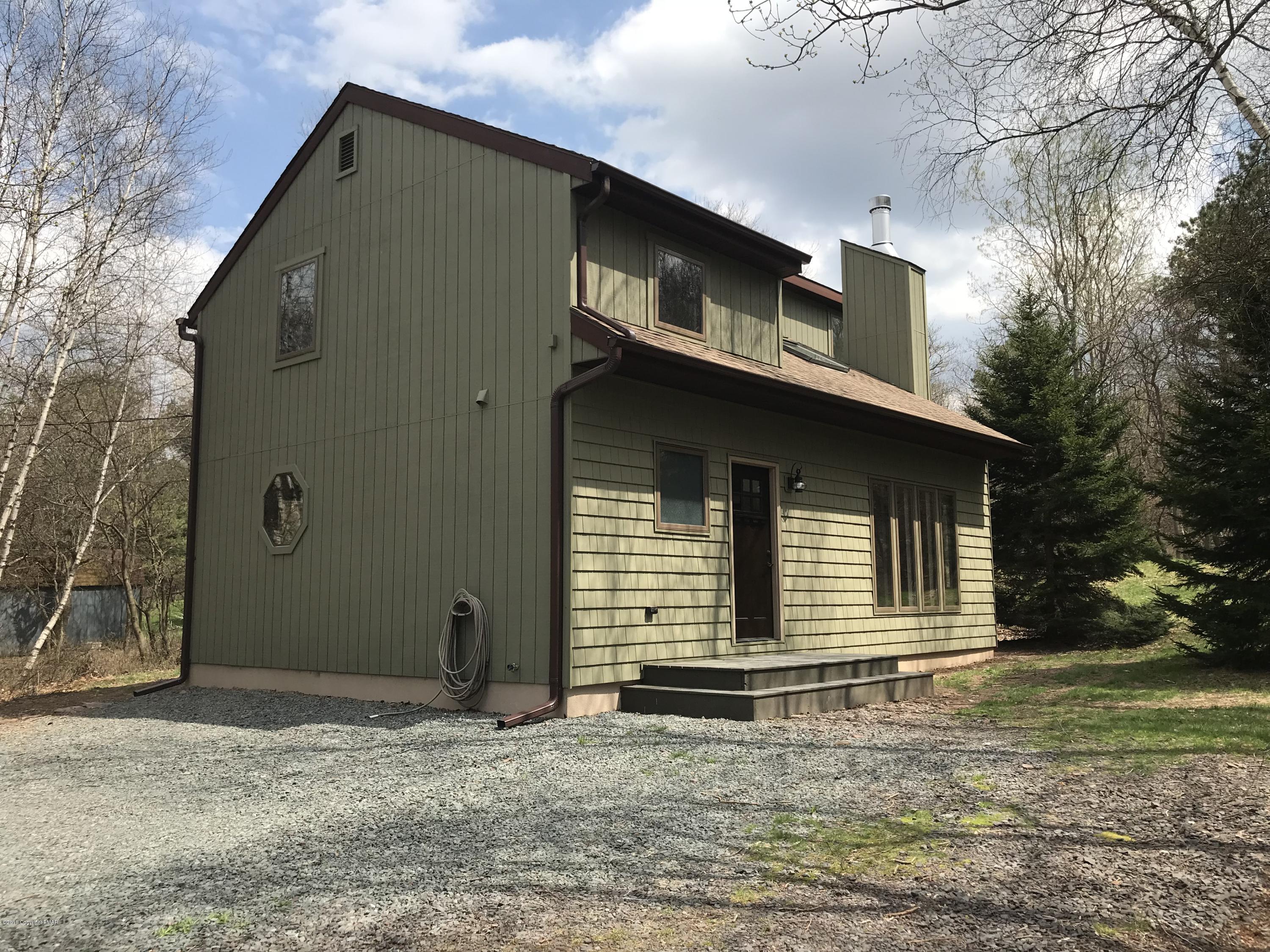 219 Ryan Road Blakeslee, PA 18610 - Photo 1 of 16 a front view of a house with garden