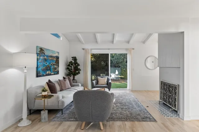 a living room with furniture and a potted plant