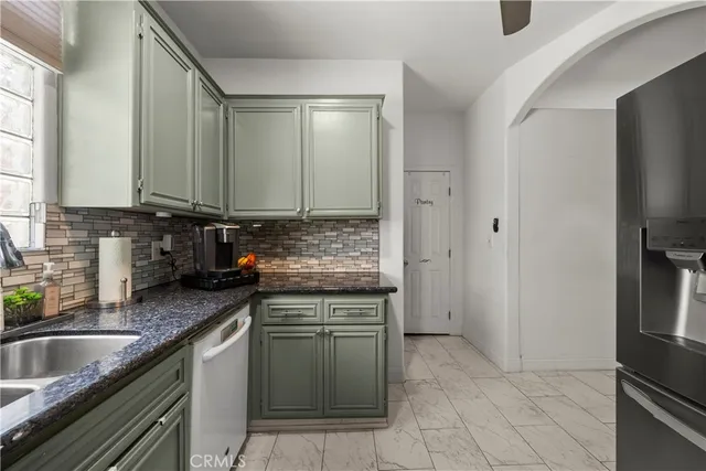 a kitchen with stainless steel appliances granite countertop a sink stove and cabinets