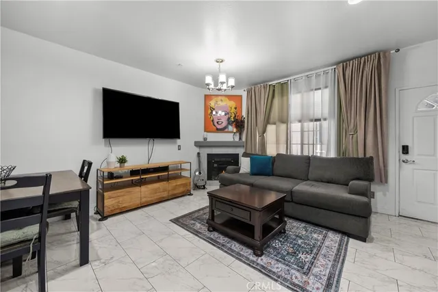 a living room with furniture a flat screen tv and a fireplace