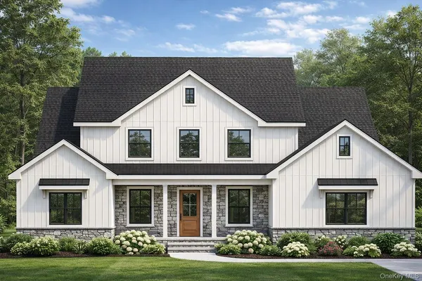 a view of a white house with yard and plants