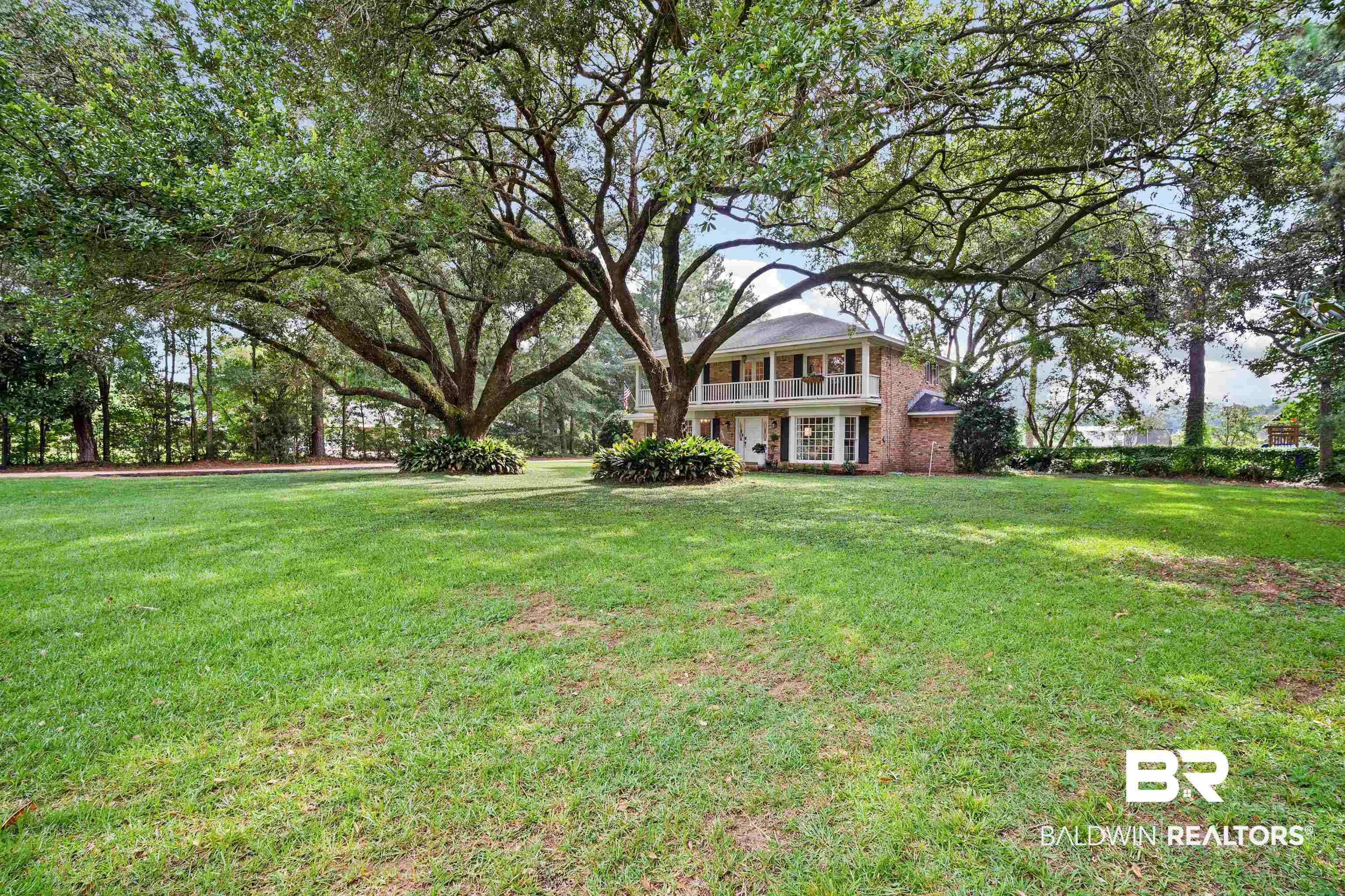 700 Eliza Jordan Road North Mobile, AL 36608 - Photo 41 of 44 View of green lawn featuring a balcony